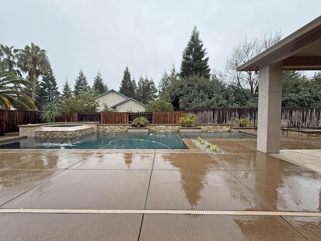 view of swimming pool with a patio area and an in ground hot tub