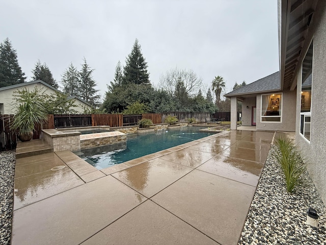 view of swimming pool featuring an in ground hot tub and a patio