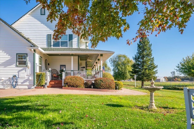 view of front of property with covered porch and a front yard