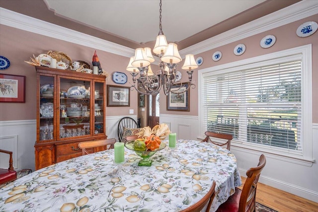 dining room featuring an inviting chandelier, wood-type flooring, and crown molding