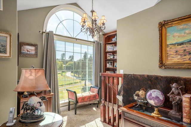 sitting room with vaulted ceiling, carpet floors, and a notable chandelier