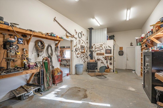 garage with a workshop area and a wood stove