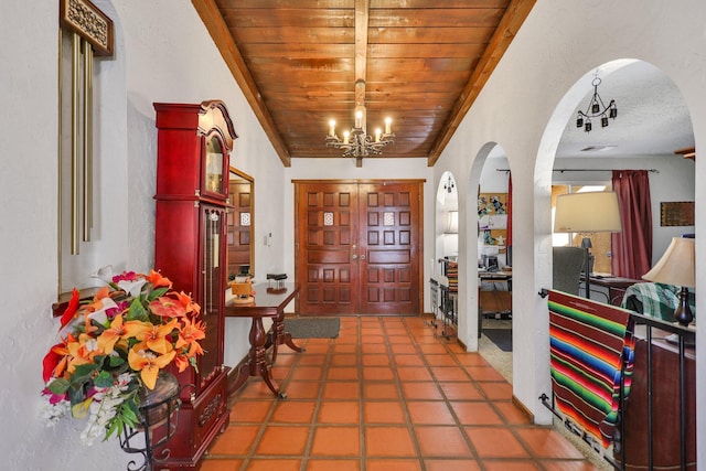 foyer featuring a notable chandelier and wooden ceiling