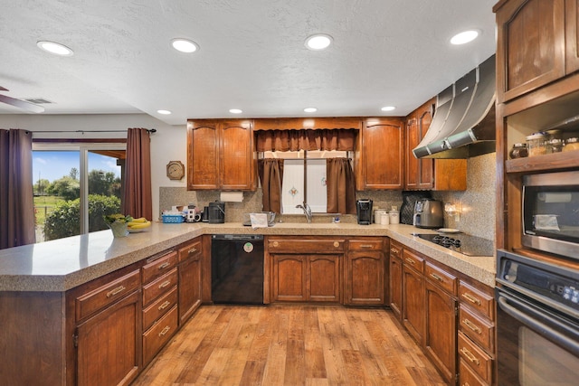 kitchen with ventilation hood, black appliances, decorative backsplash, kitchen peninsula, and light wood-type flooring