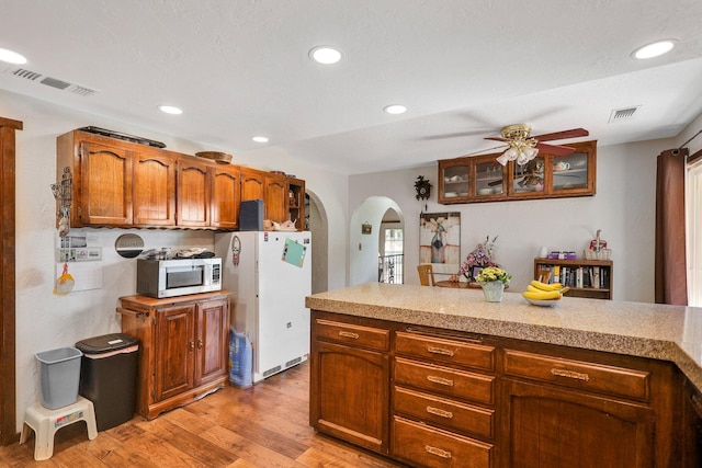 kitchen with white refrigerator, ceiling fan, and light wood-type flooring