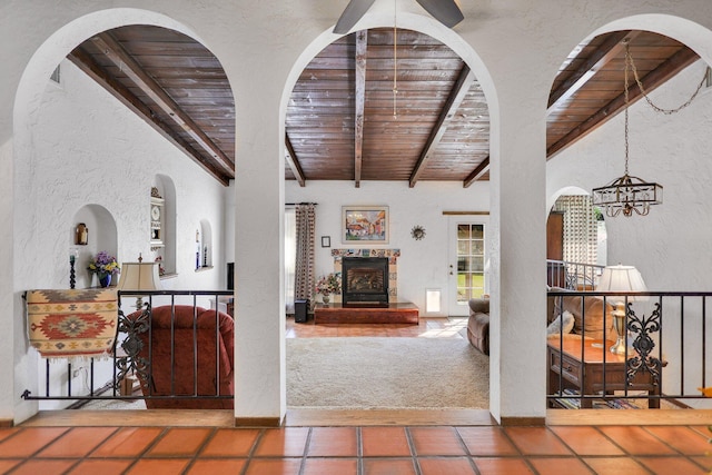 living room featuring a notable chandelier, wood ceiling, and beamed ceiling