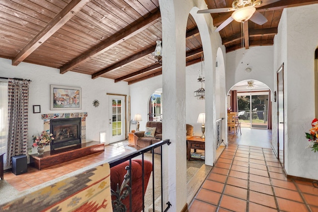 interior space featuring beam ceiling, tile patterned floors, and wood ceiling