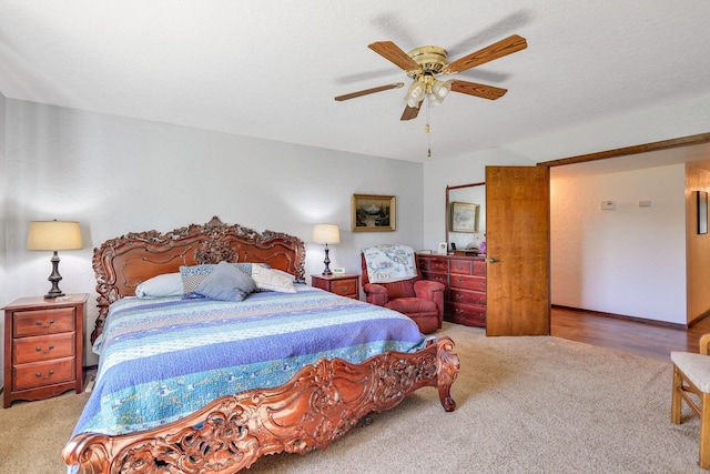 carpeted bedroom featuring a textured ceiling and ceiling fan