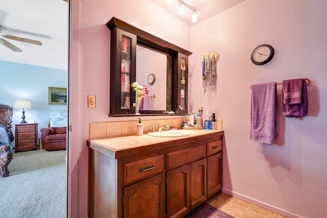 bathroom with vanity, track lighting, and ceiling fan