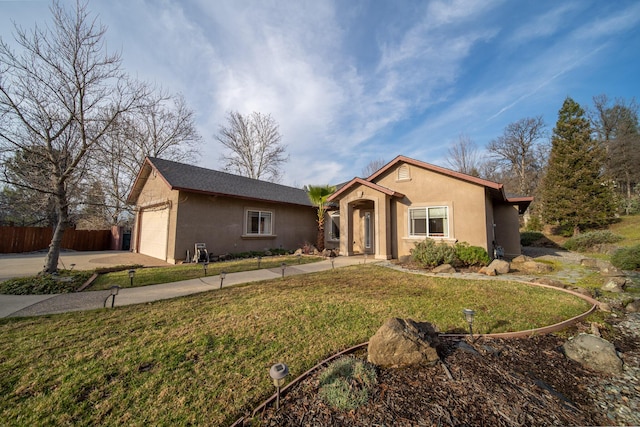 ranch-style home with a garage and a front yard