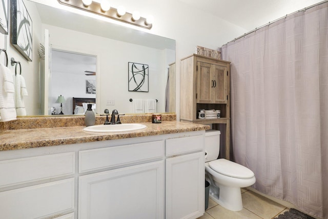 bathroom with vanity, tile patterned floors, and toilet