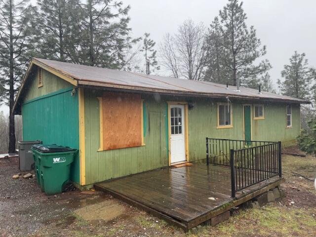 rear view of property featuring a deck