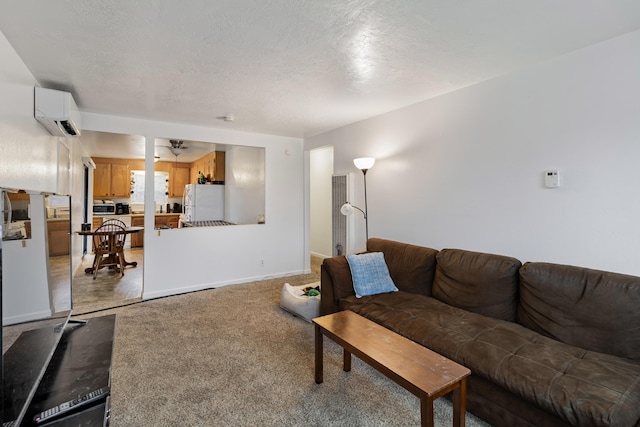 living room featuring an AC wall unit, a textured ceiling, and carpet