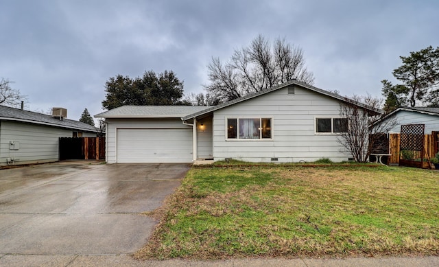 ranch-style home featuring a garage and a front lawn