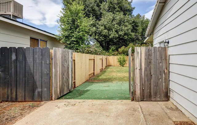 2548 Saturn, Redding, CA 96002 - view of yard featuring central air condition unit, fence, a gate, and a patio area