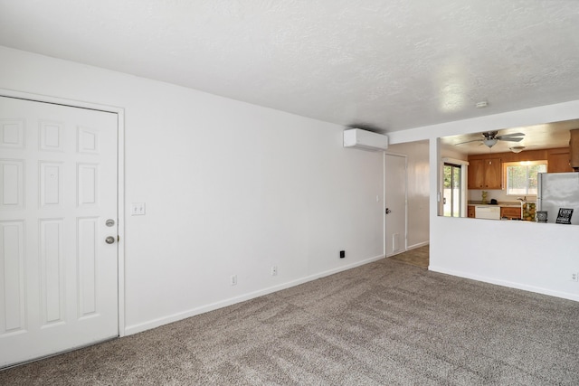 2548 Saturn, Redding, CA 96002 - unfurnished living room with carpet floors, a wall unit AC, baseboards, and ceiling fan