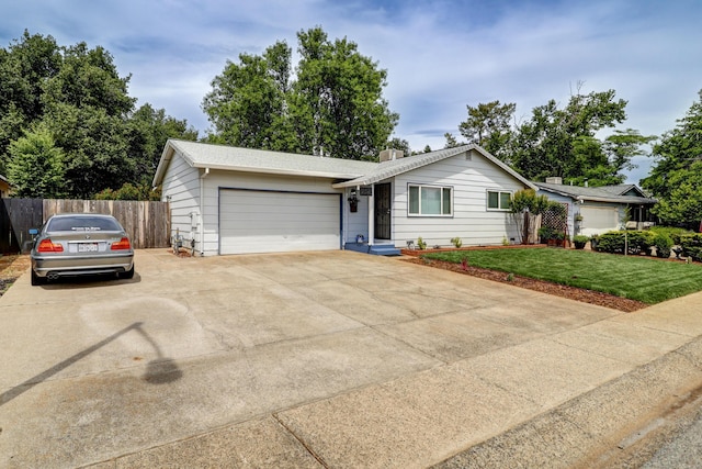 2548 Saturn, Redding, CA 96002 - ranch-style house with concrete driveway, an attached garage, and a chimney