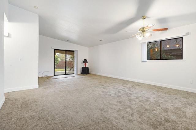 carpeted spare room with ceiling fan and lofted ceiling