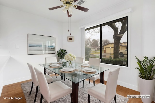 dining room with hardwood / wood-style floors and ceiling fan