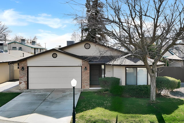 view of front of property featuring a garage and a front yard