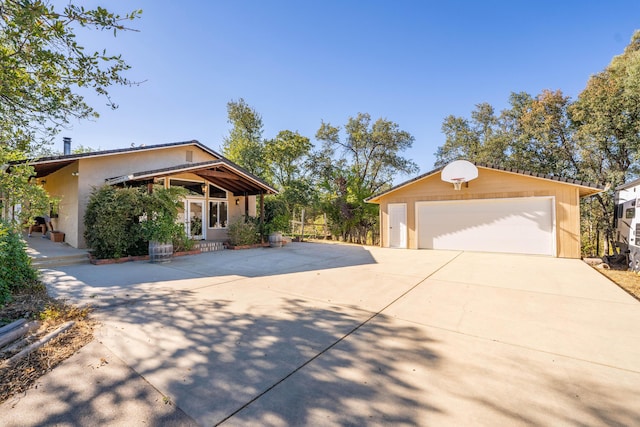 view of front of property with a garage and an outdoor structure