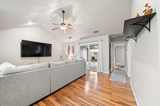 living room featuring light hardwood / wood-style flooring, ceiling fan, and vaulted ceiling