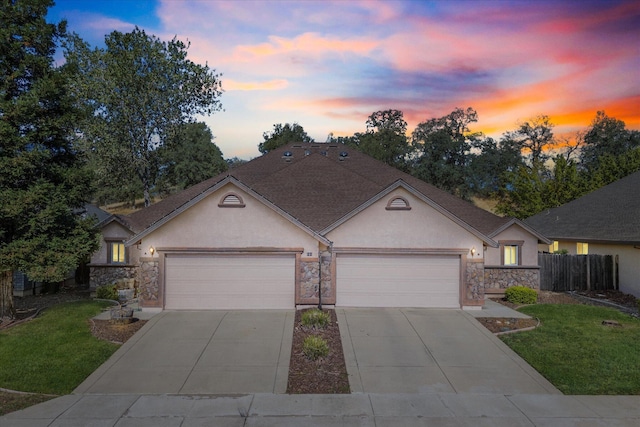 single story home with a garage and a yard