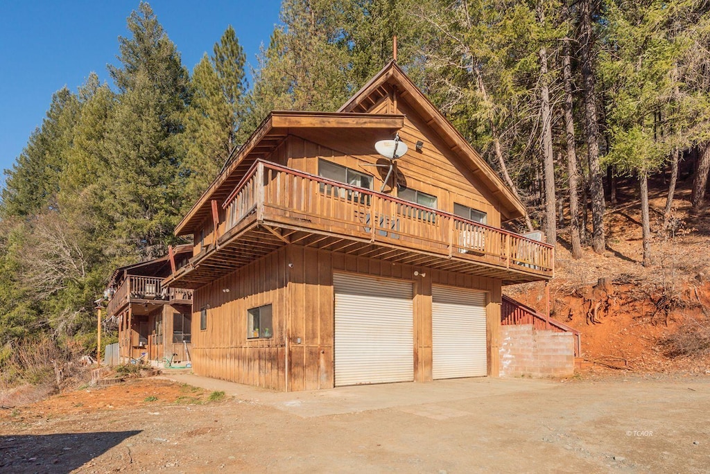 view of front facade with a wooden deck and a garage