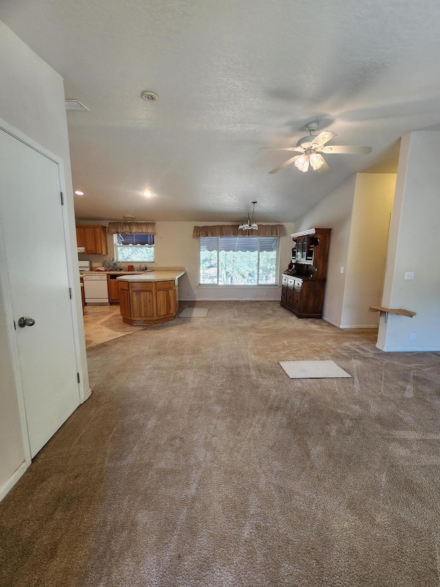 unfurnished living room featuring ceiling fan with notable chandelier, light carpet, lofted ceiling, and a textured ceiling