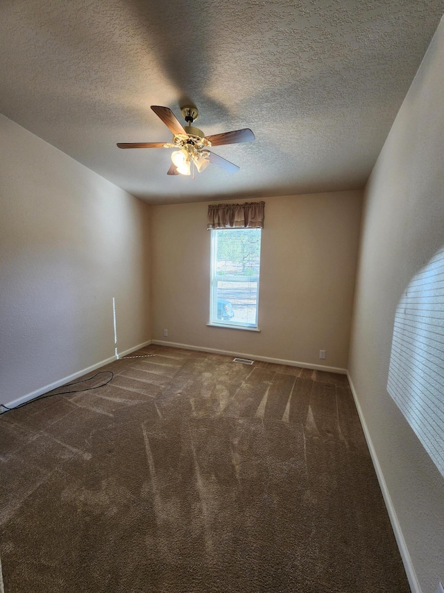 carpeted empty room with a textured ceiling and ceiling fan