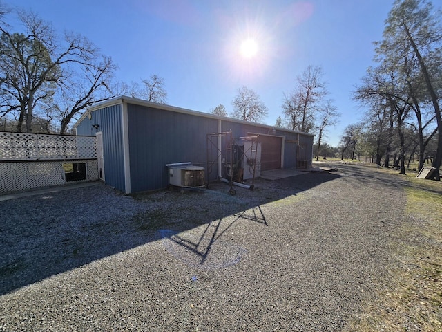 rear view of house featuring a garage