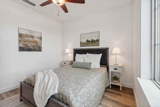 bedroom with ceiling fan and light wood-type flooring