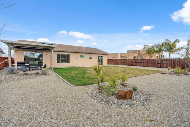 rear view of house featuring a patio and a lawn