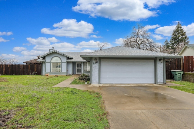 ranch-style home featuring a garage and a front yard