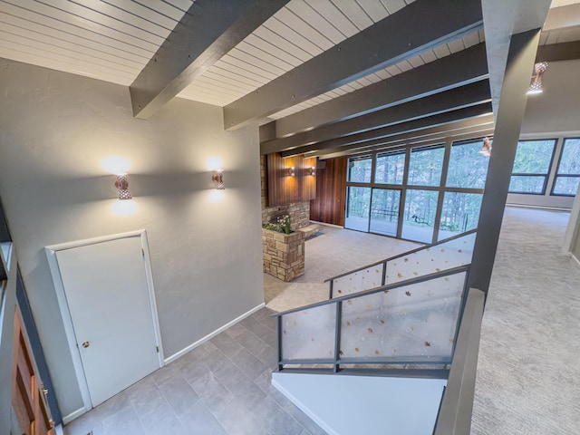 corridor with wood ceiling, beamed ceiling, and carpet