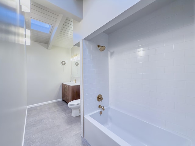 full bathroom with a skylight, beamed ceiling, tiled shower / bath combo, vanity, and toilet