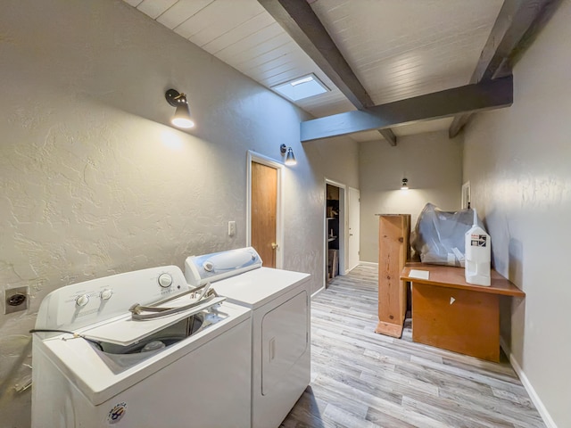 washroom with washer and clothes dryer and light hardwood / wood-style flooring