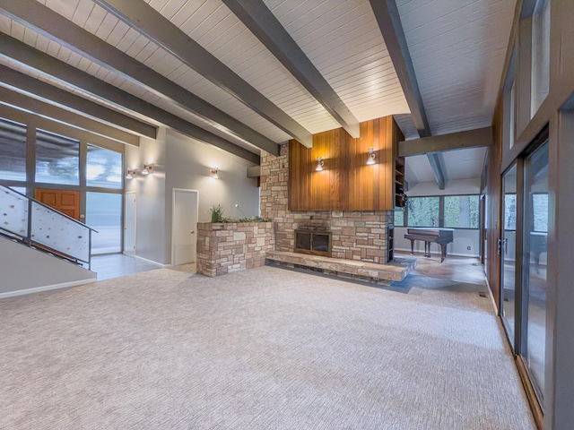 unfurnished living room with light carpet, vaulted ceiling with beams, and a stone fireplace