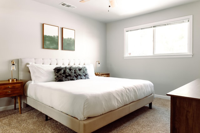 bedroom featuring baseboards, visible vents, and light colored carpet