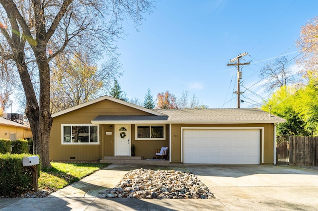 ranch-style house featuring a shingled roof, concrete driveway, crawl space, fence, and a garage