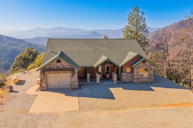 view of front of home with a garage and a mountain view