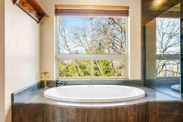 bathroom with tiled bath