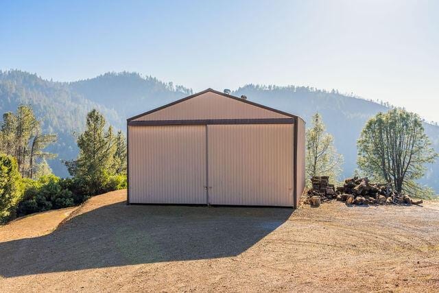 view of outbuilding with a mountain view