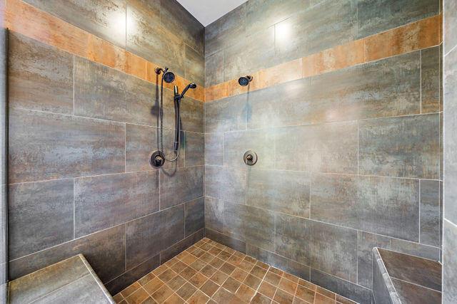 bathroom with tiled shower