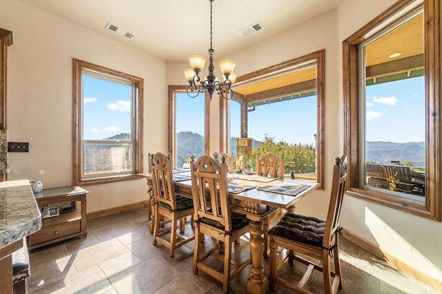 dining room featuring a chandelier and a mountain view