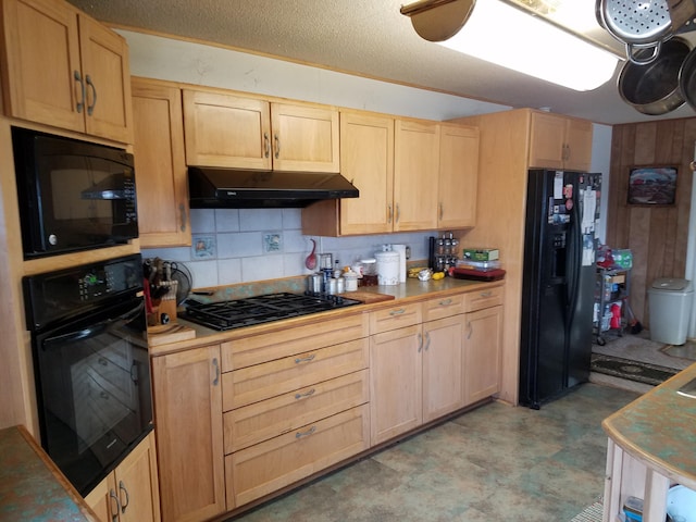 kitchen featuring tasteful backsplash, black appliances, light brown cabinetry, light floors, and under cabinet range hood