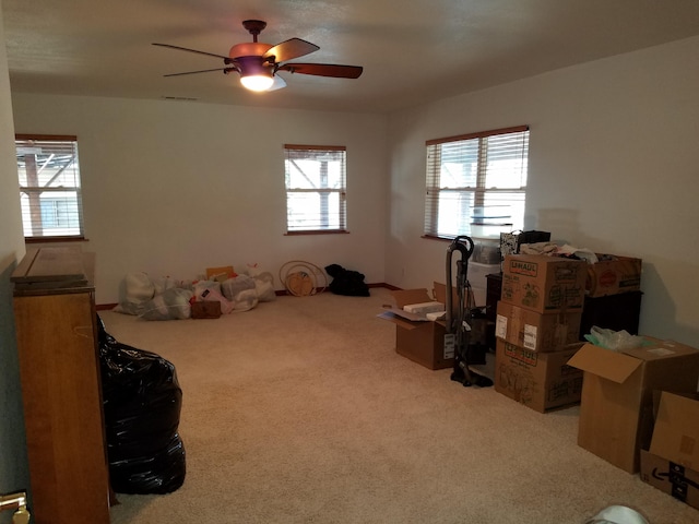 interior space featuring visible vents, carpet, and ceiling fan