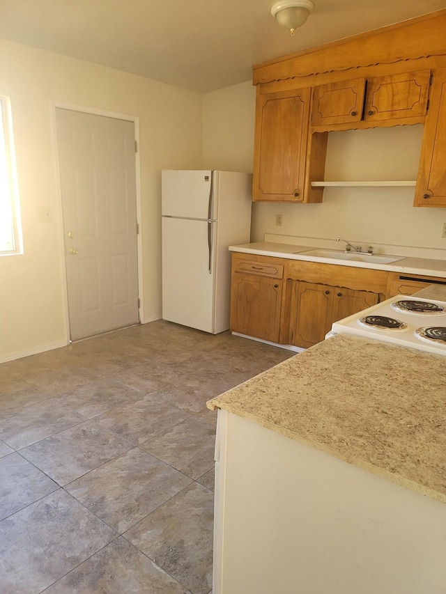 kitchen featuring white appliances and sink