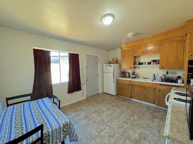 kitchen with sink and white fridge