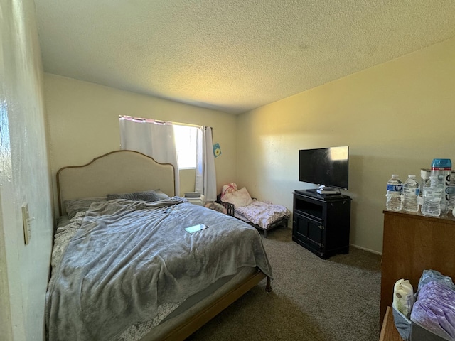 bedroom with a textured ceiling and carpet flooring